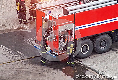 Firefighters rescue extinguish a fire in a residential building. Necessary fire equipment in a fire truck, help Stock Photo