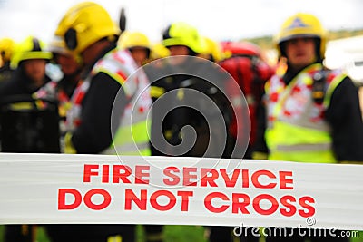 Firefighters behind the cordon at a fire. Editorial Stock Photo