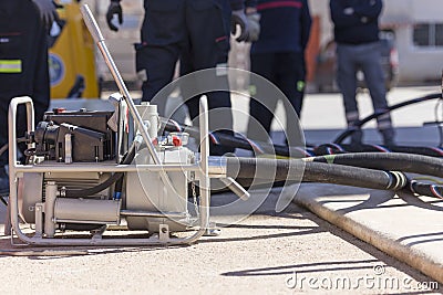 Firefighters working with a suction pump Stock Photo