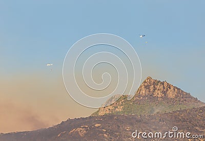 Firefighting Using Helicopters in the Mountains Stock Photo