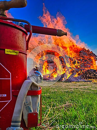 Firefighting vehicle is in the foreground of a large, blazing wildfire. Stock Photo