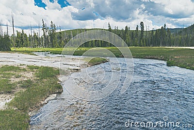 The Firehole River, going through the Black Sand Geyser Basin area of Yellowstone National Park Stock Photo