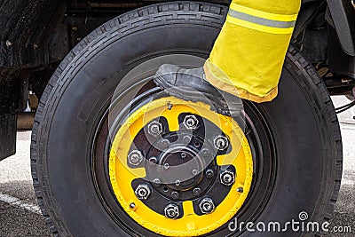 Fireman boot standing on large wheel. Stock Photo