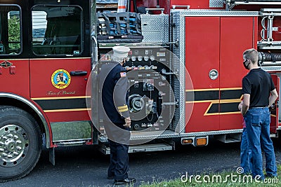 Fireman demonstrates equipment on firetruck just blessed Editorial Stock Photo
