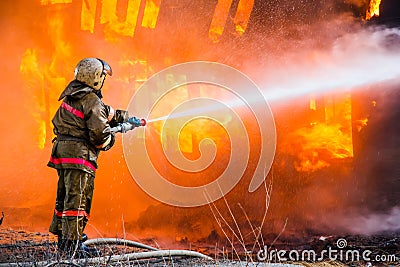 Fireman extinguishes a fire Stock Photo