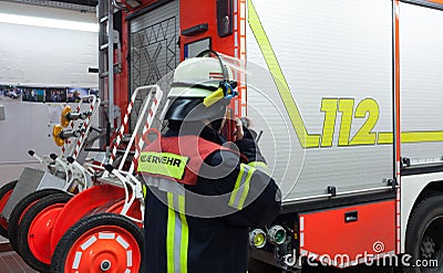 Fireman in a fire department fire truck spark with radios set Stock Photo