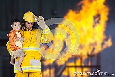 Fireman rescued the child from the fire Stock Photo