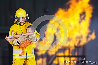 Fireman rescued the child from the fire Stock Photo