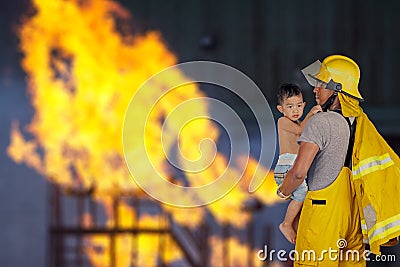 Fireman rescued the child from the fire Stock Photo