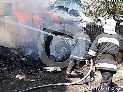 fireman spraying water firefighters extinguish a fire in an apartment house Stock Photo