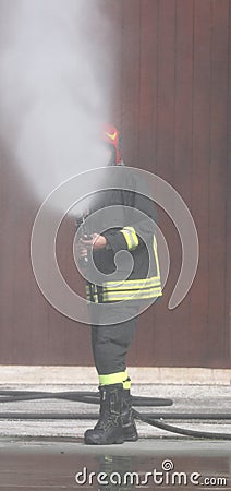 fireman uses a nebulized foam to extinguish a big fire Stock Photo