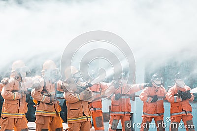 Fireman using water and extinguisher to fighting with fire flame Editorial Stock Photo