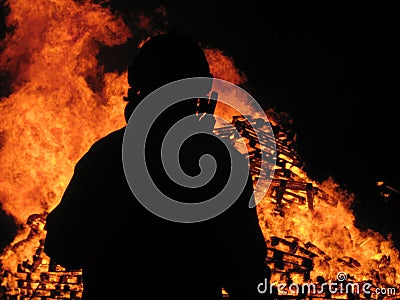 Fireman watches over inferno Stock Photo