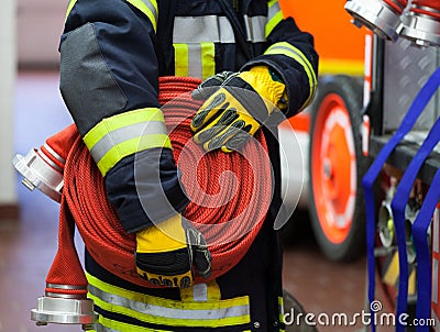 A Fireman with water hose Stock Photo