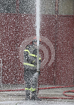 fireman who uses the foam and creates an intentionally out of fo Stock Photo