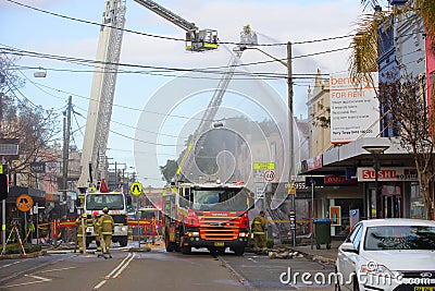 Firemen douse flames after explosion at a convenience store in R Editorial Stock Photo