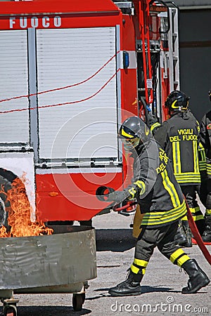 Firemen extinguish a simulated fire during an exercise in their Editorial Stock Photo