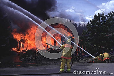 Firemen fighting house fire Editorial Stock Photo