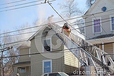 Firemen fighting house fire Editorial Stock Photo