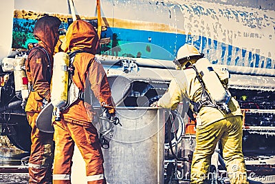 Firemen in firefighter uniform are checking their equipment after use. Stock Photo