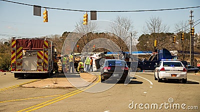 Firemen and workmen with overturned logging truck Editorial Stock Photo