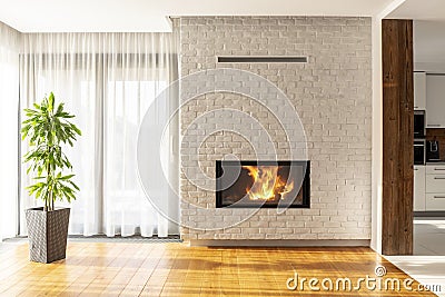 Fireplace on brick wall in bright living room interior of house Stock Photo