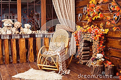 Fireplace collected from logs, rocking-chair and furs in the room Stock Photo