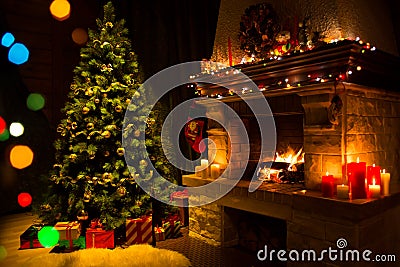 Fireplace and decorated Christmas tree and candles Stock Photo