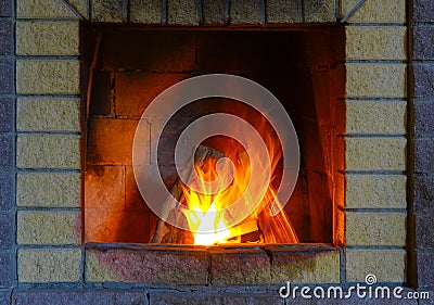 Fireplace made of silicate bricks. A fire is burning in the fireplace Stock Photo