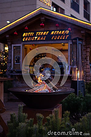 Fireplace at traditional christmas market Christkindlmarkt at Hotel Terme Meran Merano, South Tyrol Italy Editorial Stock Photo