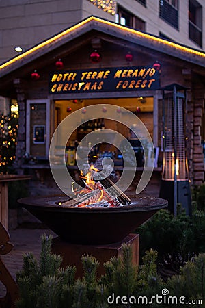 Fireplace at traditional christmas market Christkindlmarkt at Meran Merano, South Tyrol Italy Editorial Stock Photo