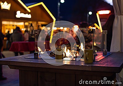 Fireplace at traditional christmas market Christkindlmarkt at Meran Merano, South Tyrol Italy Stock Photo