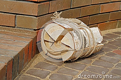 Firewood bundle tied with a rope on the pavement Stock Photo