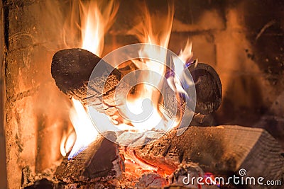 Firewood burning in fireplace fire heat red ashes Stock Photo