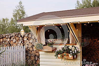 Firewood-filled shed in a neat backyard Stock Photo
