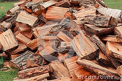 Firewood is stacked in autumn. Chopped pile of wood. Lots of wood from logs. Preparation of firewood for the winter. background te Stock Photo