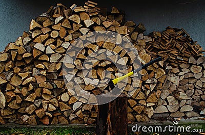 Firewood is stacked in a row, prepared for heating rooms in the cold season Stock Photo