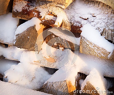 Firewood, wood with snow in winter Stock Photo