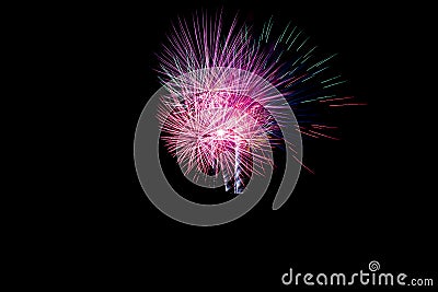 firework celebration, with a multiple long exposure to capture the movement of the explosion.black sky background Stock Photo