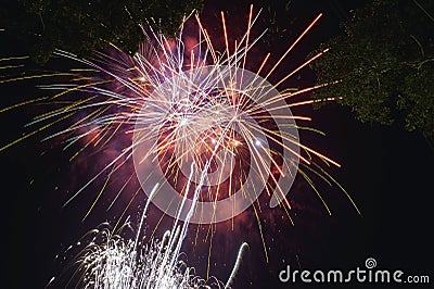 Fireworks explode in the dark sky celebrating the annual festival Stock Photo
