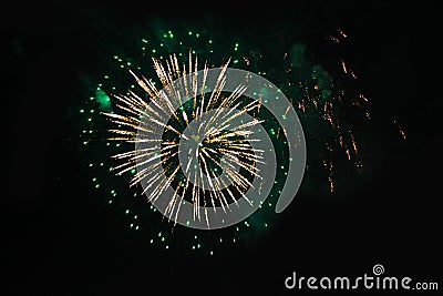 Fireworks. Firework. A fountain of brightly colored and green sparkling lights in the night sky during the New Year and Christmas Stock Photo