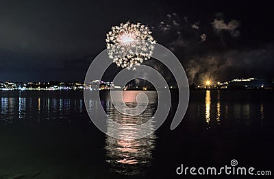 The fireworks paint the sky in various colors and are reflected in the Miseno lake, creating a breathtaking view. Stock Photo