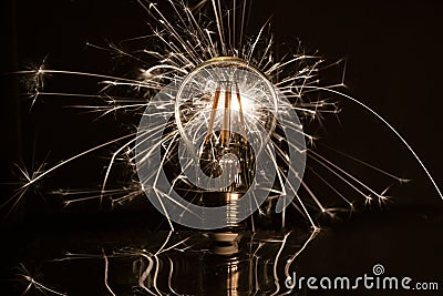 Fireworks sparkler showing through LED light bulb Stock Photo