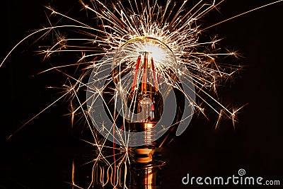 Fireworks sparkler showing through LED light bulb Stock Photo