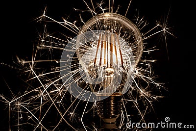 Fireworks sparkler showing through LED light bulb Stock Photo