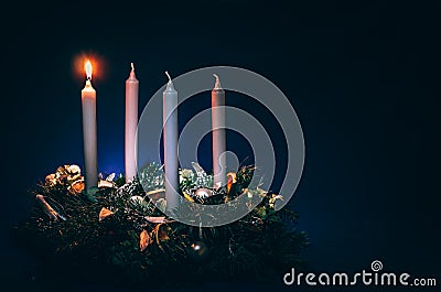 First advent candles burning on black background Stock Photo