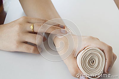 First aid accident wrist with liniment Stock Photo