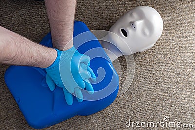 First aid and cardiopulmonary resuscitation training on a CPR dummy, a human shaped doll used to improve the skills and technique Stock Photo