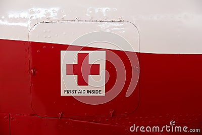 First aid cross and first aid inside title on a metal cabinet door Editorial Stock Photo