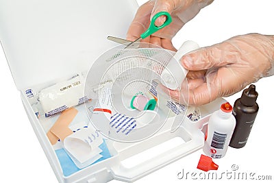 First-aid kit and hands with gloves Stock Photo